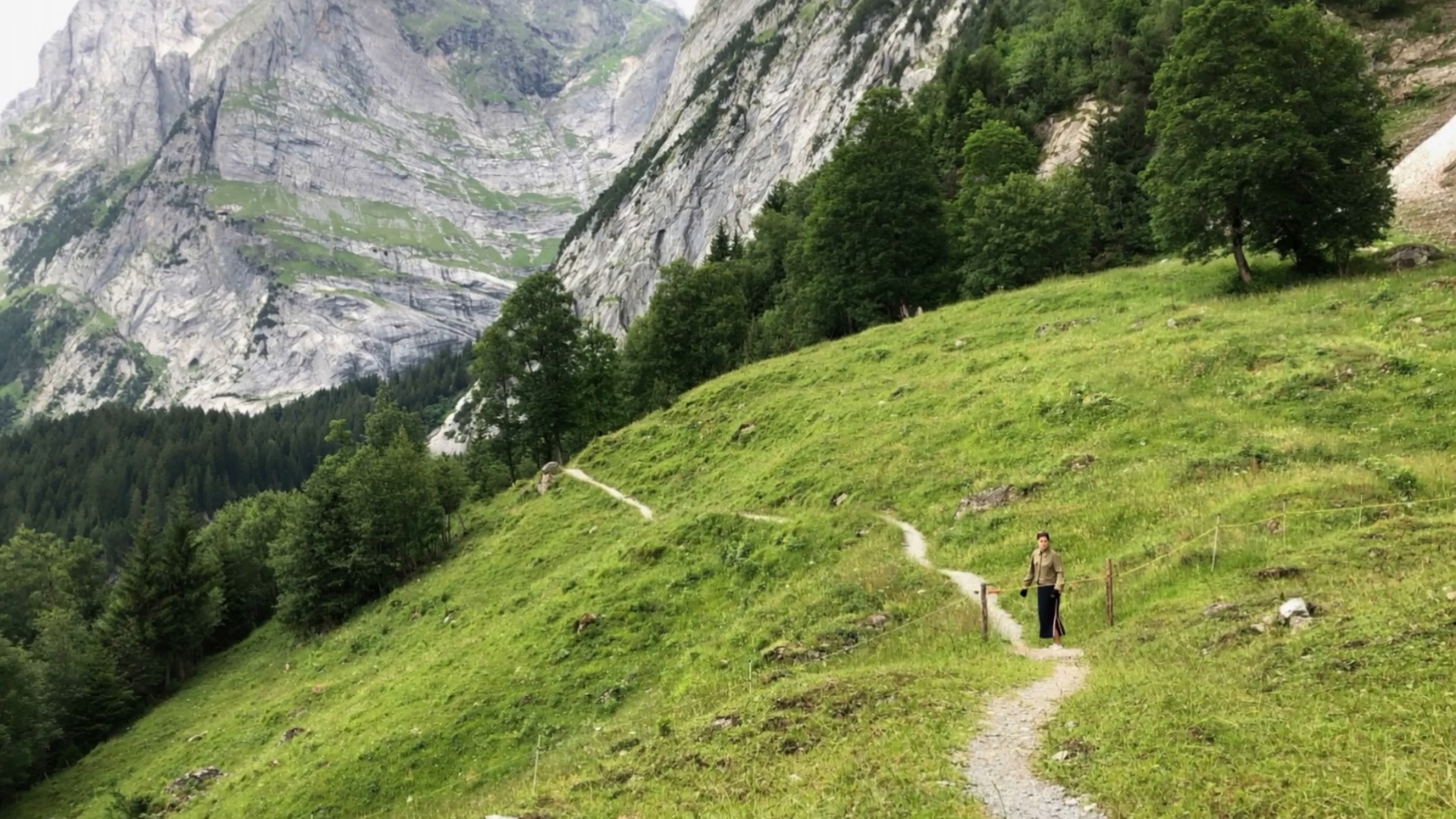 Alice on a Swiss mountain path, with a white grid highlighting her spot and the what3words address ///diner.certified.sparrows